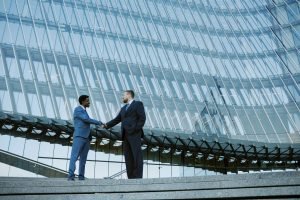 Shaking Hands in Corporate Glass Building