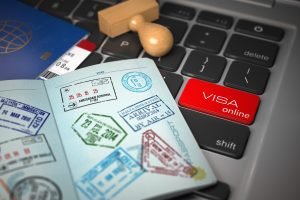 Visa online application concept. Open passport with visa stamps